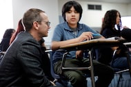 Education Commissioner Mike Morath visits with eighth grader Oziel Leyva as he observes a...