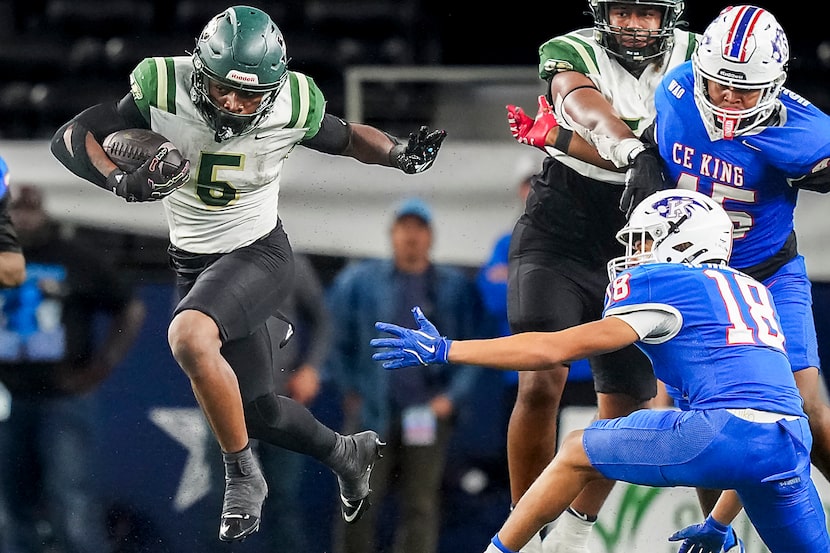 DeSoto running back Sarod Baker (5) gets past C.E. King linebacker Xavier Williams (18)...