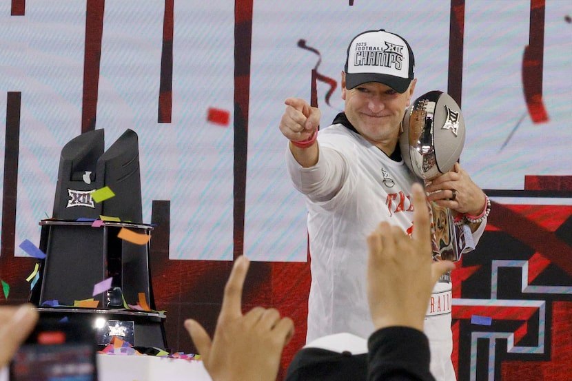 Texas Tech head coach Joey McGuire holds the trophy after their victory against the BYU in...