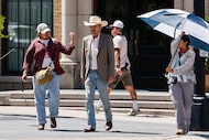 Actor Billy Bob Thornton walks with production crew members while filming season two of the...