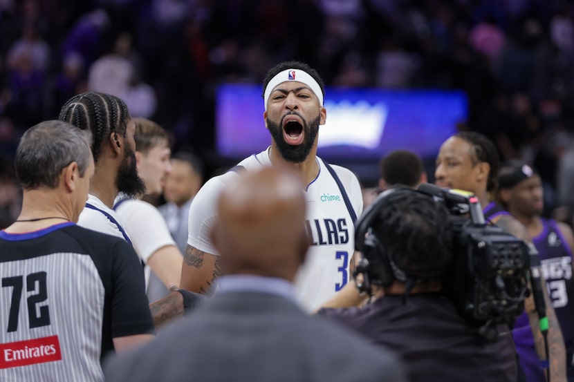 Dallas Mavericks forward Anthony Davis (3) yells back towards a group of fans after the...