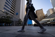 Pedestrians walk through AT&T Discovery District past the communications company’s...