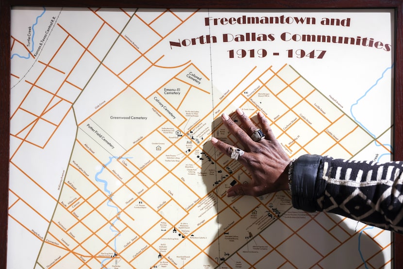 Professor Clarence Glover puts his hand on a map of Freedmantown as he shares insights about...