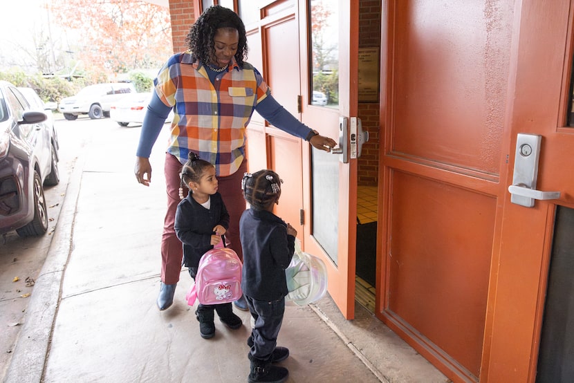 Brenda Holmes pulls the door open for daughter Aniyah Cossey, center, and granddaughter...