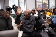 Edward Lee Smith (center), Tommy Lee Walker’s son, throws his hands up after a Dallas County...