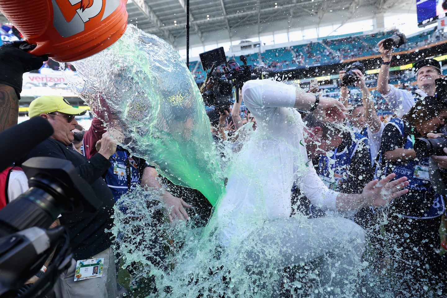 Oregon players pour Gatorade over head coach Dan Lanning after their Orange Bowl win over Texas Tech. 