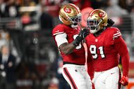 San Francisco 49ers defensive tackle Sam Okuayinonu (91) and defensive lineman Clelin...