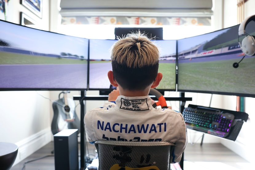 Liam Nachawati demonstrates a kart racing simulator in his home near White Rock Lake.