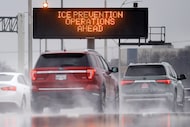 An ice prevention operations warning sign along southbound Interstate 35E is reflected in...