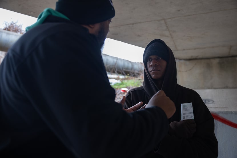 Lekevie Johnson, a street outreach manager with OurCalling, speaks with Kendrian Yarbrough...