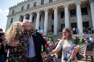 Texas A&M University President Mark Welsh, center, and his wife, Betty Welsh, right, exit...