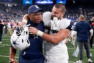 Dallas Cowboys tight end Jake Ferguson (87) hugs tight ends coach Lunda Wells as they walk...