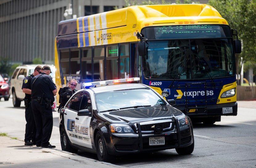 DART officers work near a DART police car on Thursday, August 3, 2017 near the West End DART...