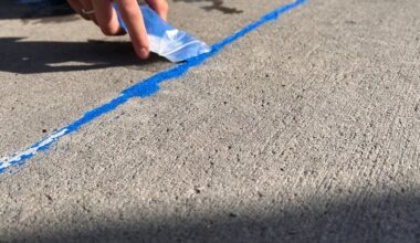 Volunteers fill Lubbock sidewalk gaps with blue sand to raise human trafficking awareness