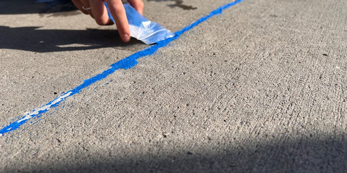 Volunteers fill Lubbock sidewalk gaps with blue sand to raise human trafficking awareness
