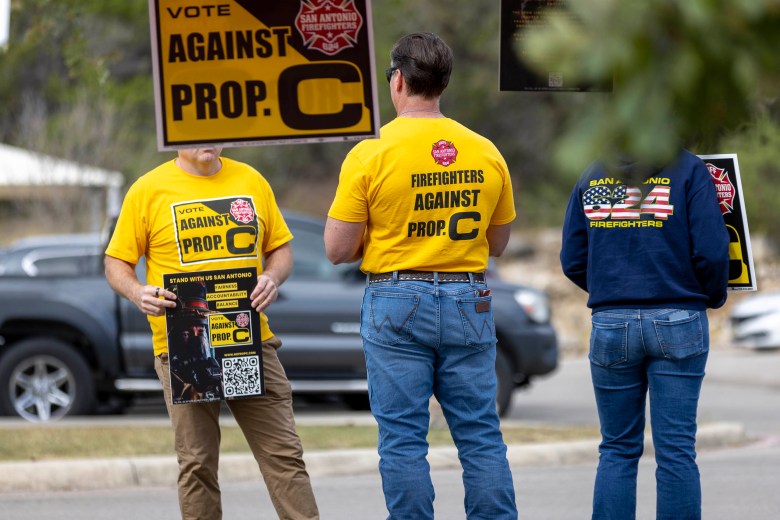 Members of the San Antonio Professional Fire Fighters Association campaign against Proposition C on the ballot, a an amendment to the City's charter that would allow City Council to set the terms regarding the pay and tenure of the city manager.