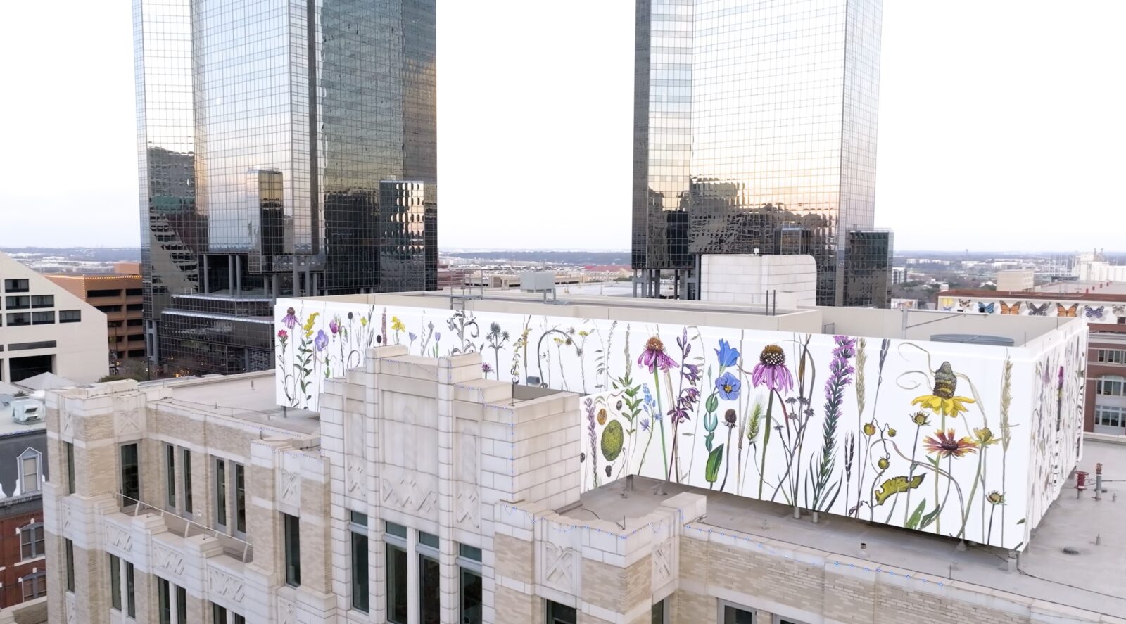 A wildflower mural on top of a city building
