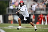 Cincinnati quarterback Brendan Sorsby looks for a receiver during the first half of an NCAA...