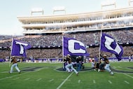 The TCU Rangers run onto the field with flags before an NCAA football game against Colorado,...