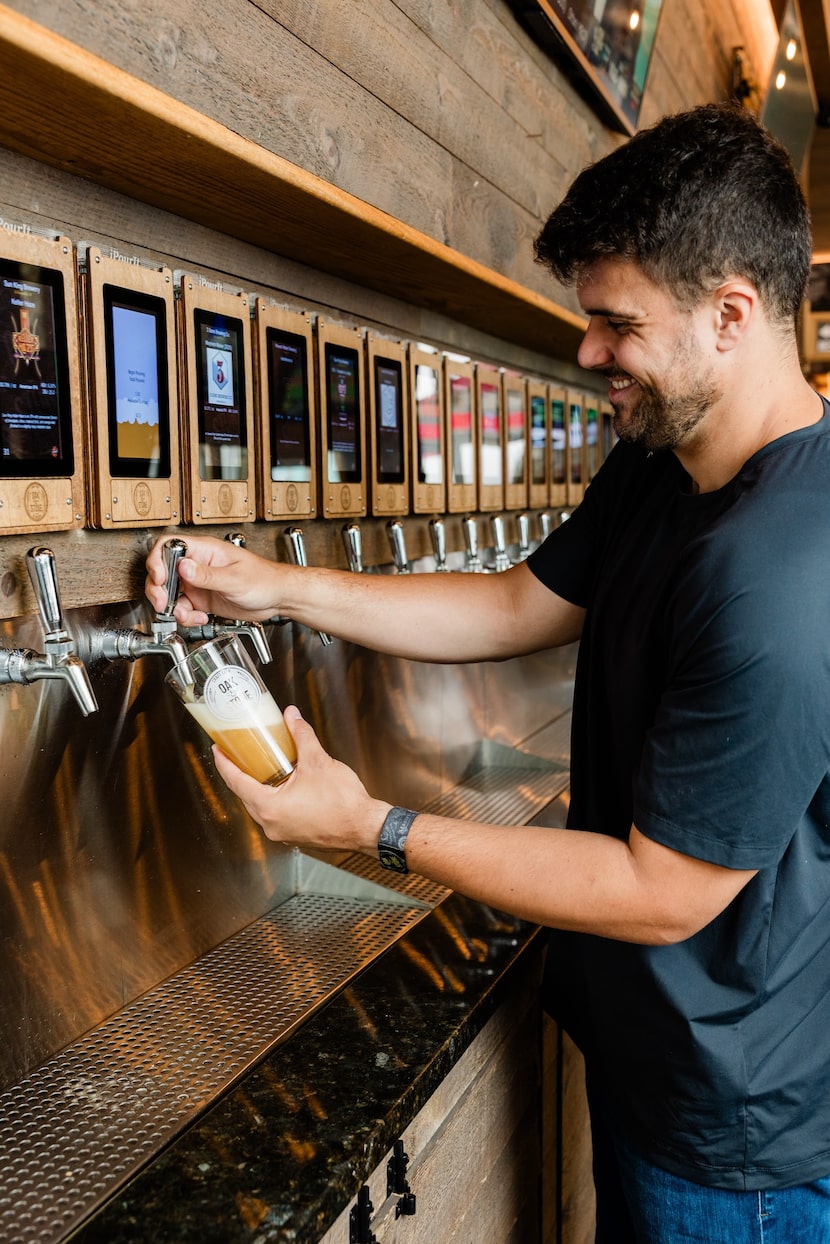 The selection of drinks in the self-pour tap wall includes beer, wine, bourbon, whiskey,...