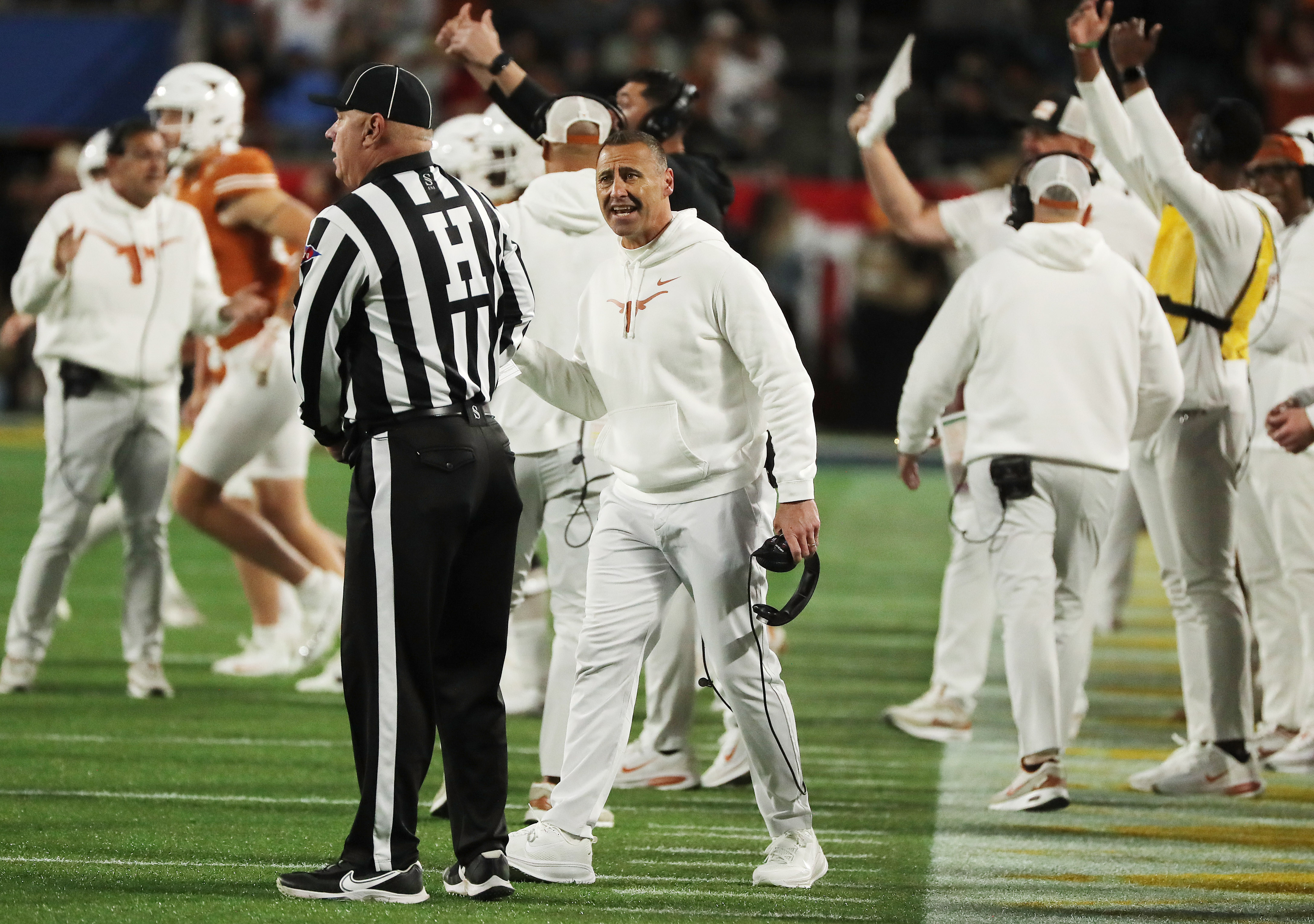 Texas head coach Steve Sarkisian yells at head line judge...