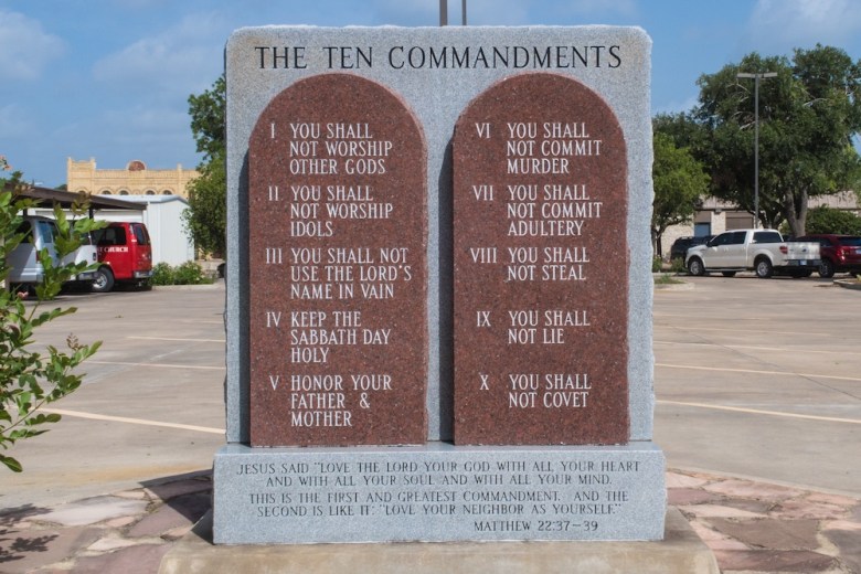 A monument of the Ten Commandments stands beside a parking lot in Cuero, Texas.