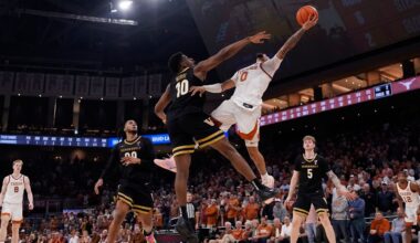 Texas guard Jordan Pope (0) drives to the basket against Vanderbilt forward Ak Okereke (10) during the second half of an NCAA college basketball game in Austin, Texas, Wednesday, Jan. 14, 2026. (AP Photo/Eric Gay)