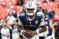 Dallas Cowboys quarterback Joe Milton III (10) warms up before an NFL football game against...