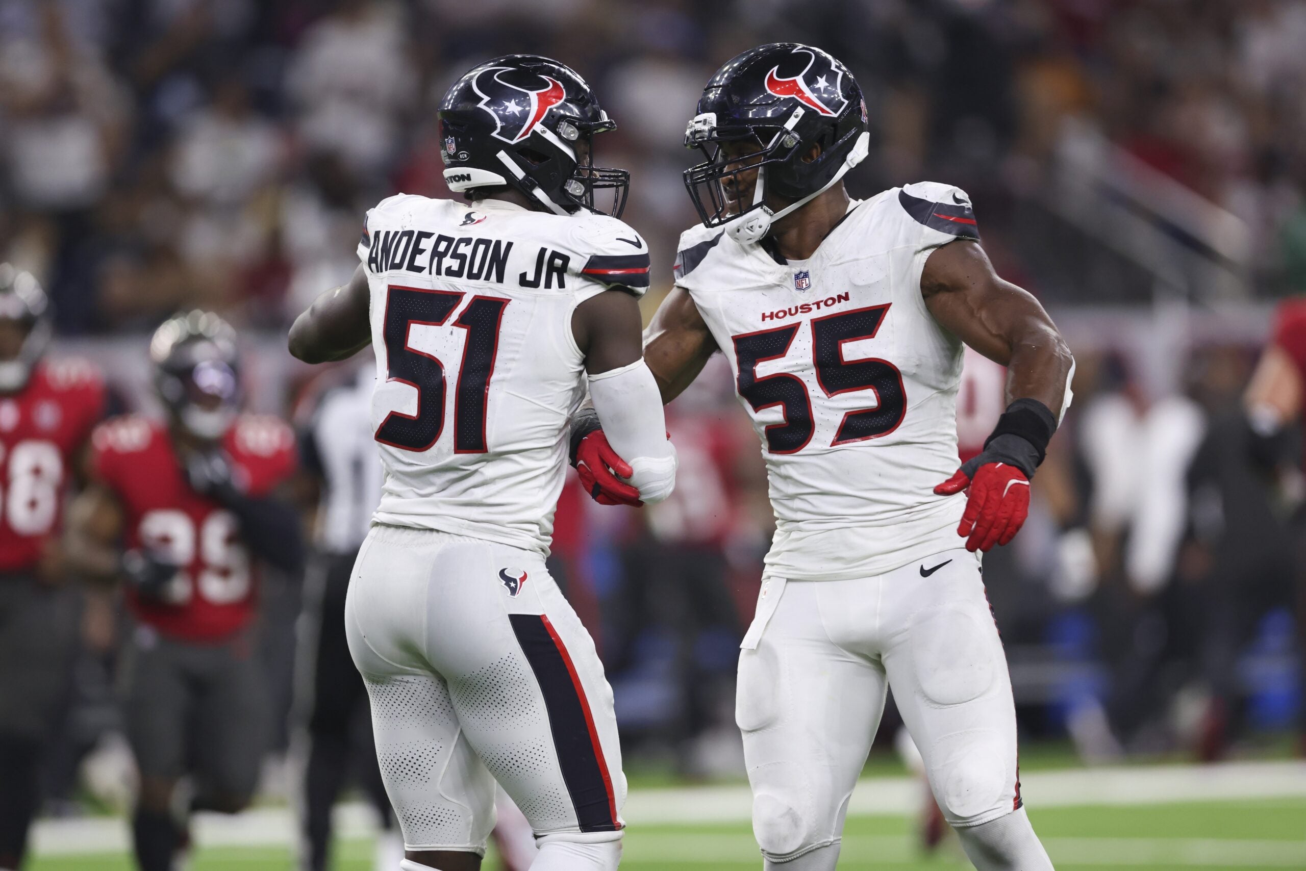 Sep 15, 2025; Houston, Texas, USA; Houston Texans defensive end Will Anderson Jr. (51) celebrates with defensive end Danielle Hunter (55) after a defensive play during the fourth quarter against the Tampa Bay Buccaneers at NRG Stadium. Mandatory Credit: Troy Taormina-Imagn Images