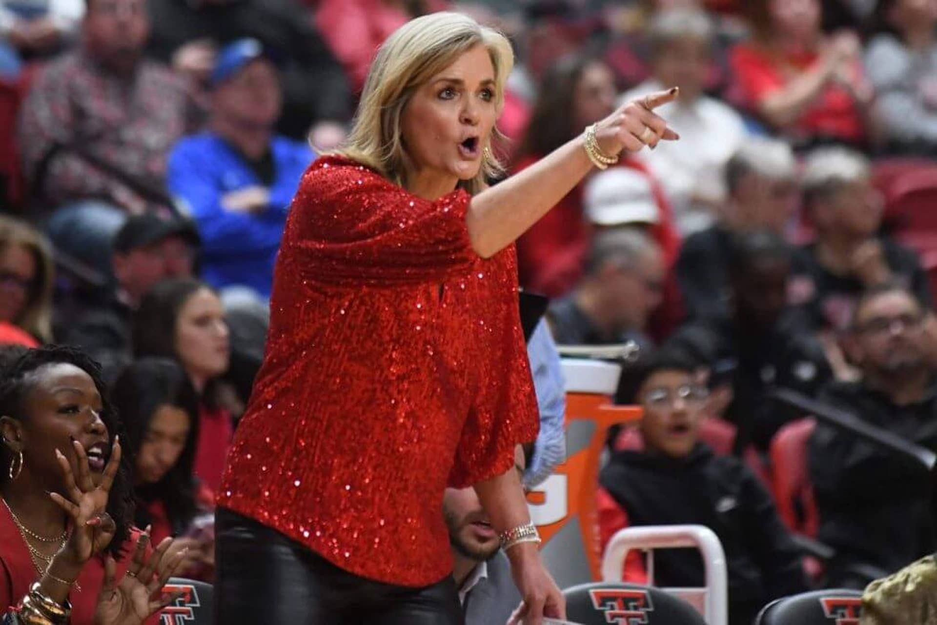 Texas Tech women's basketball coach Krista Gerlich points toward the court.