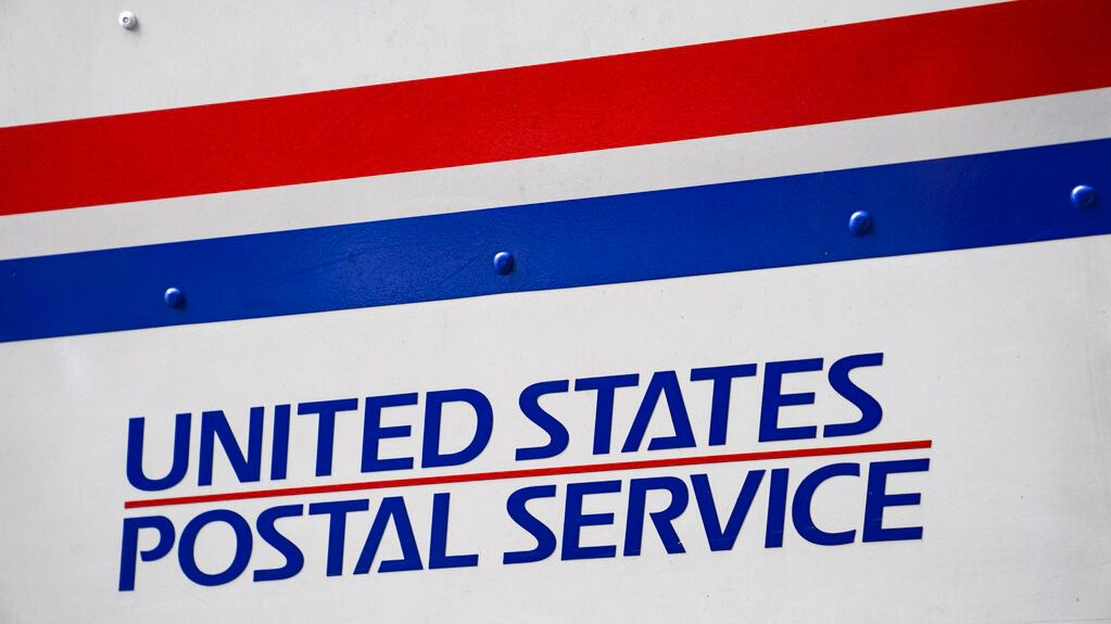 A U.S. Postal Service delivery truck is parked beside the Canal Street station, Monday, Aug. 17, 2020, in New York. (AP Photo/John Minchillo)