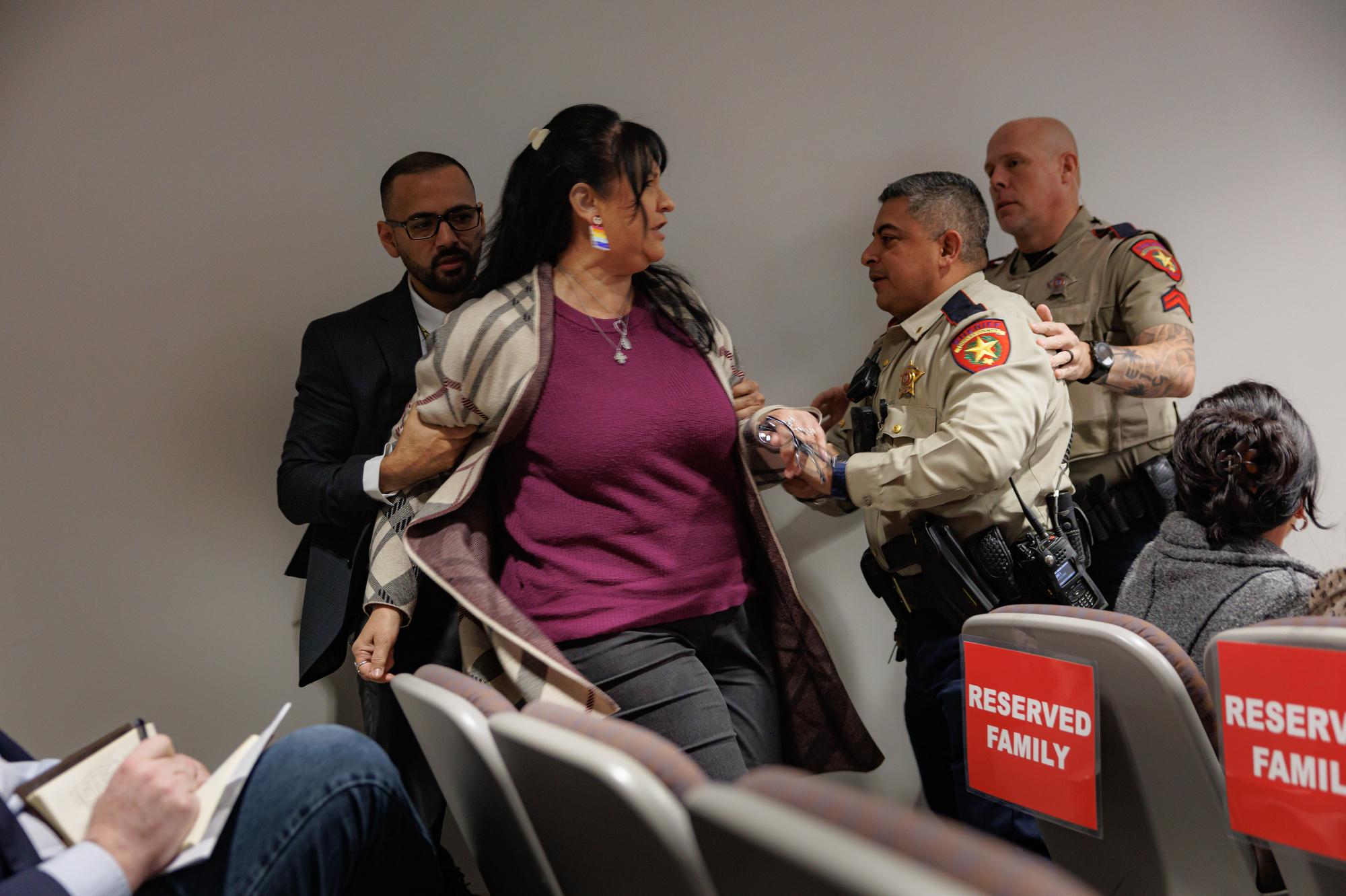 Police officers escort Velma Lisa Duran of the courtroom as...