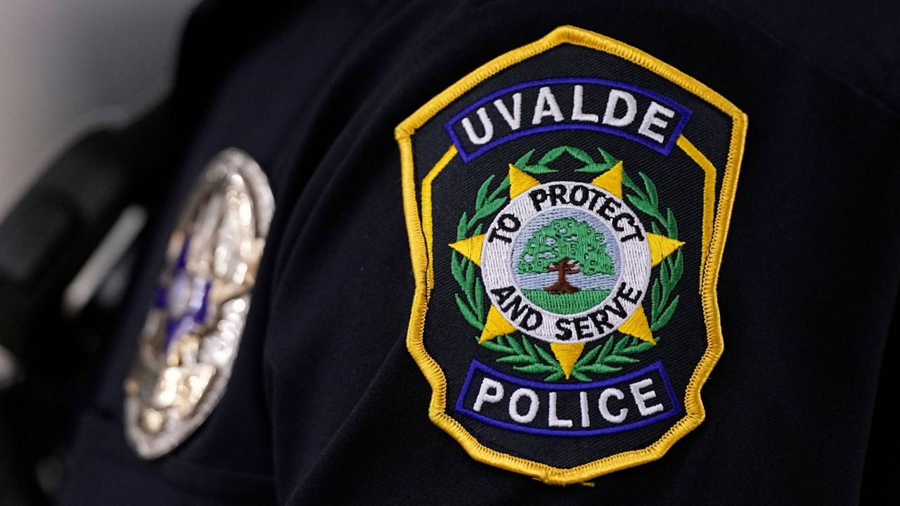 A Uvalde police officers patch a badge are seen as he stands watch over a special city council meeting in Uvalde, Texas, Thursday, March 7, 2024. (AP Photo/Eric Gay)
