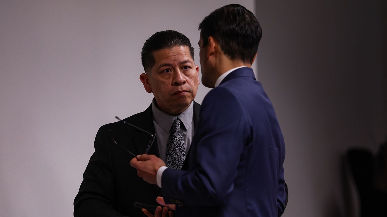 Former Uvalde school district police officer Adrian Gonzales, left, talks to his defense attorney Nico LaHood during a break on the 10th day of his trial at Nueces County Courthouse in Corpus Christi, Texas, Tuesday, Jan. 20, 2026. (Sam Owens/The San Antonio Express-News via AP, Pool)