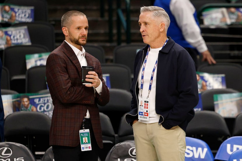 Matt Riccardi, Dallas Mavericks co-interim general manager (left), speaks to Phoenix Suns...