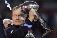 FILE - New England Patriots head coach Bill Belichick holds up the Vince Lombardi Trophy as...