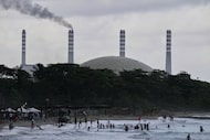 The El Palito refinery rises above a beach in Puerto Cabello, Venezuela, Sunday, Dec. 21,...