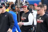 Texas Tech head coach Joey McGuire, center, stands on the sideline during the first half of...