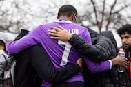 Woodrow Wilson High School senior Ashwin Persaud (center) embraces soccer teammates during a...