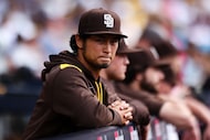 San Diego Padres' Yu Darvish looks on from the dugout during a baseball game against the...