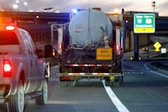 A TxDOT truck drives alongside East Rosedale Street as it prepares to spray brine ahead of...