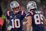 New England Patriots quarterback Drake Maye (10) and tight end Hunter Henry (85) celebrate...