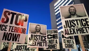 Demonstrators hold signs during a rally against federal immigration enforcement at Federal Courthouse Plaza on Tuesday, Jan. 27, 2026, in Minneapolis. (AP Photo/Adam Gray)