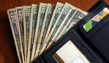 In this June 15, 2018, file photo, cash is fanned out from a wallet in North Andover, Mass.  (AP Photo/Elise Amendola)