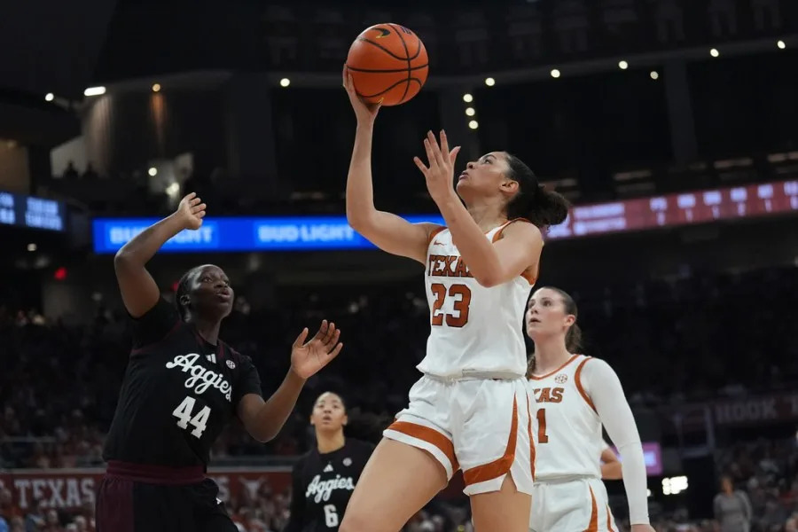 Texas guard Aaliyah Crump (23) drives to the basket against Texas A&M forward Fatmata Janneh (44) during the second half of an NCAA college basketball game in Austin, Texas, Sunday, Jan. 18, 2026. (AP Photo/Eric Gay)