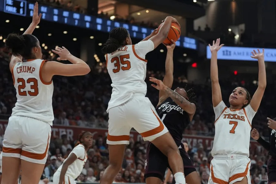 Texas A&M guard Ny’ceara Pryor (1) is blocked by Texas forward Madison Booker (35) as she tries to score during the first half of an NCAA college basketball game in Austin, Texas, Sunday, Jan. 18, 2026. (AP Photo/Eric Gay)