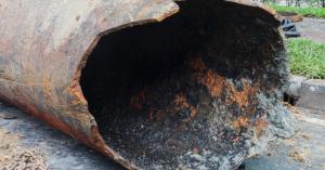 Close up of cast iron pipe corrosion in Plano, TX