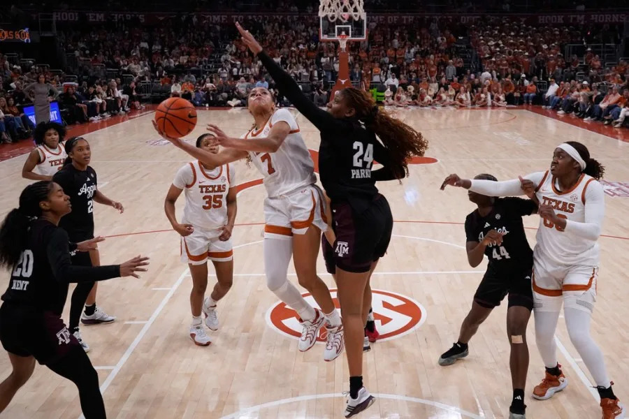 Texas guard Jordan Lee (7) drives to the basket against Texas A&M center Emerald Parker (24) during the second half of an NCAA college basketball game in Austin, Texas, Sunday, Jan. 18, 2026. (AP Photo/Eric Gay)