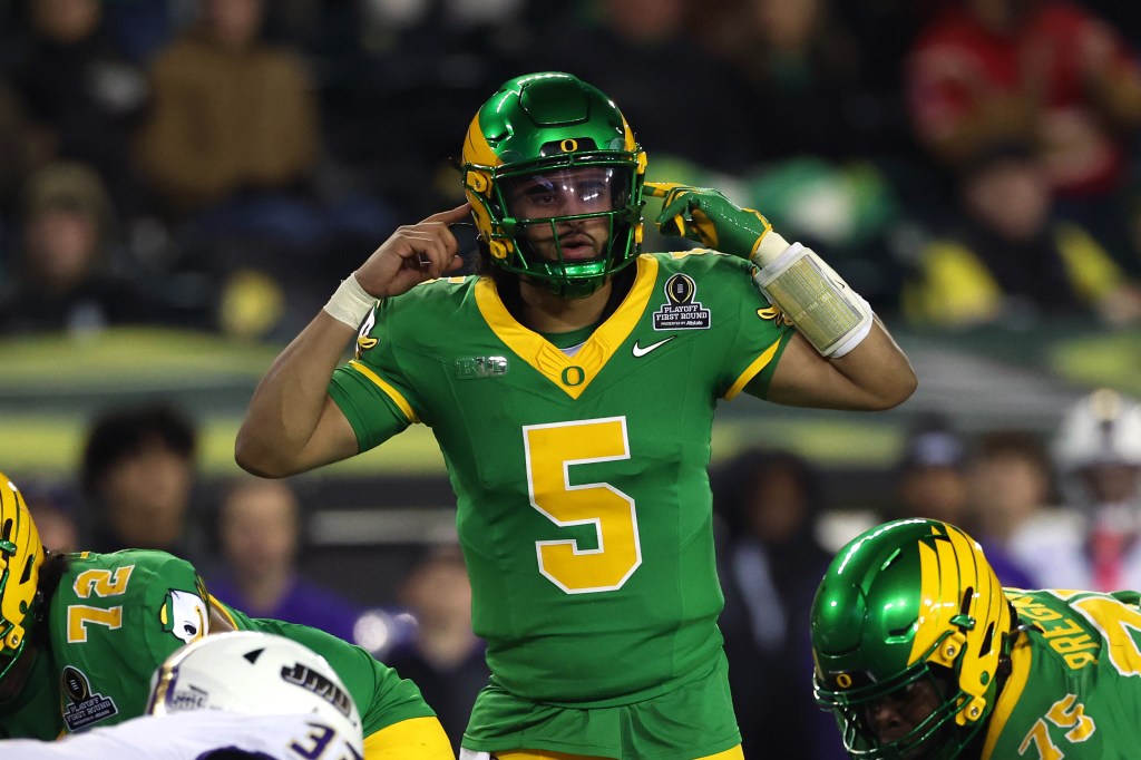 Dante Moore, #5 of the Oregon Ducks, directs his team during the fourth quarter of a game.