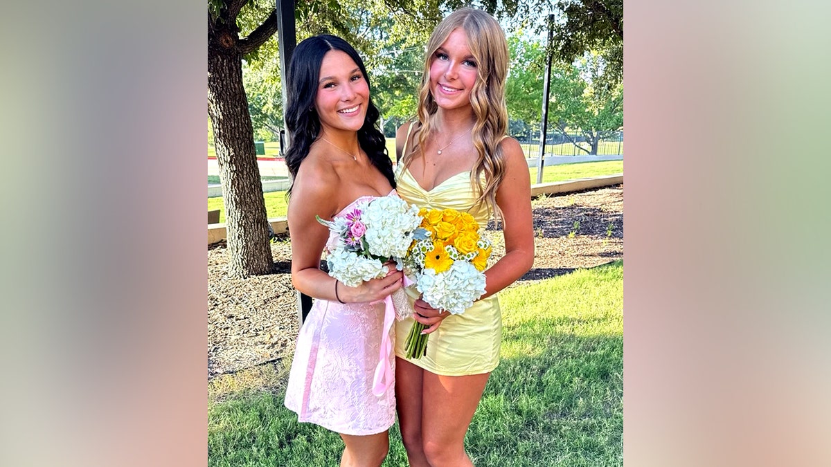 Grace Brito and Elizabeth Angle smiling in dresses and holding flower bouquets 